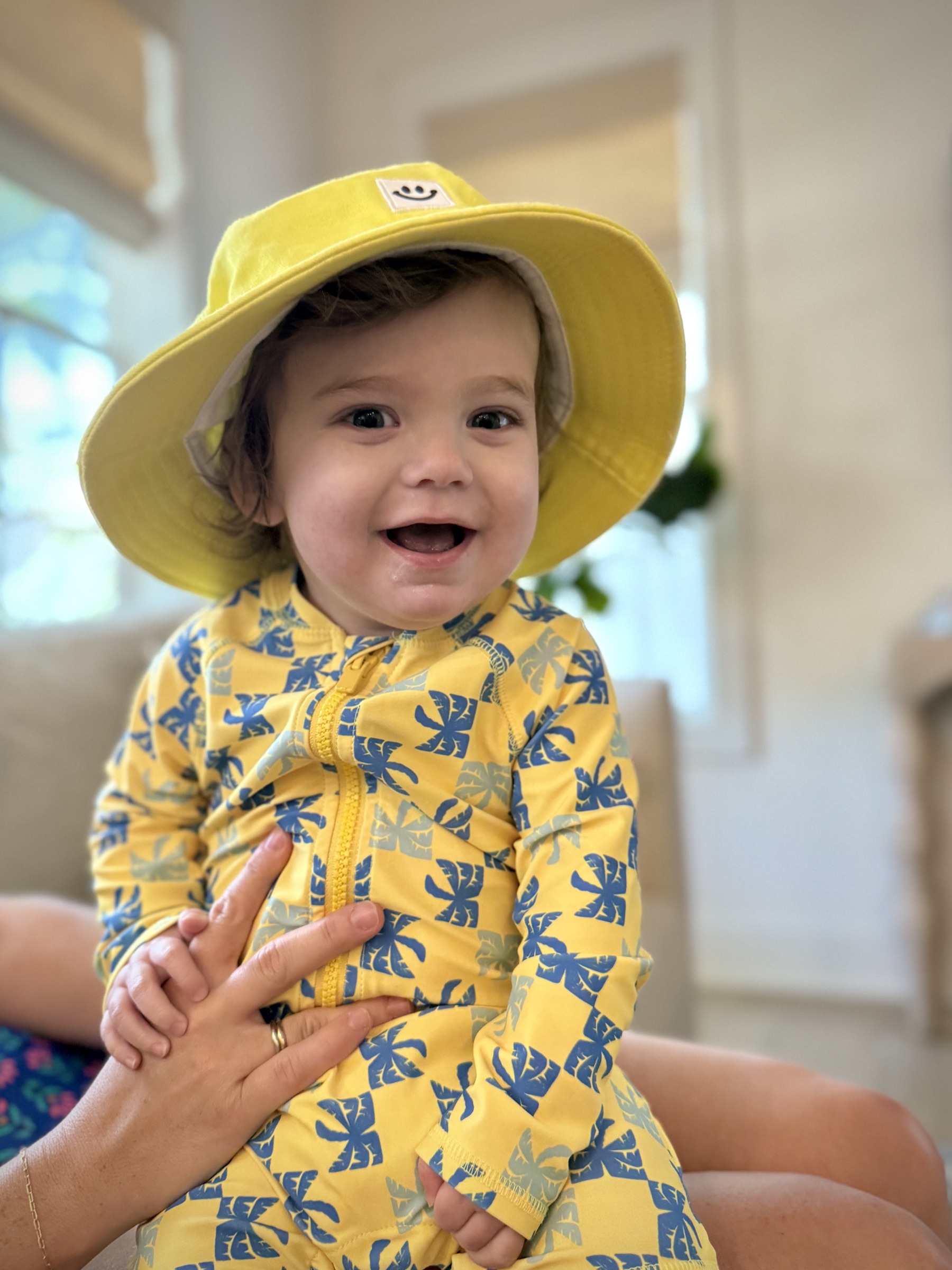Brooks smiling in a yellow sun hat