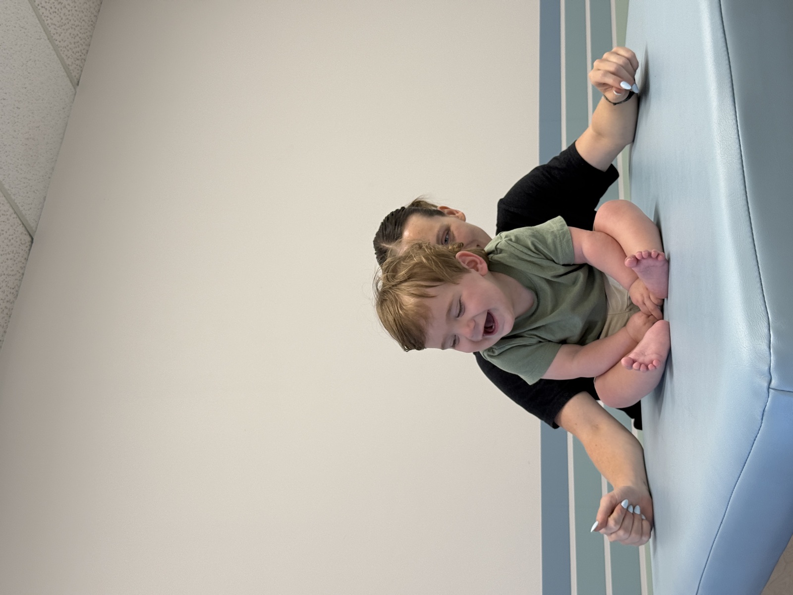 Brooks laughing with his therapist during a seated exercise